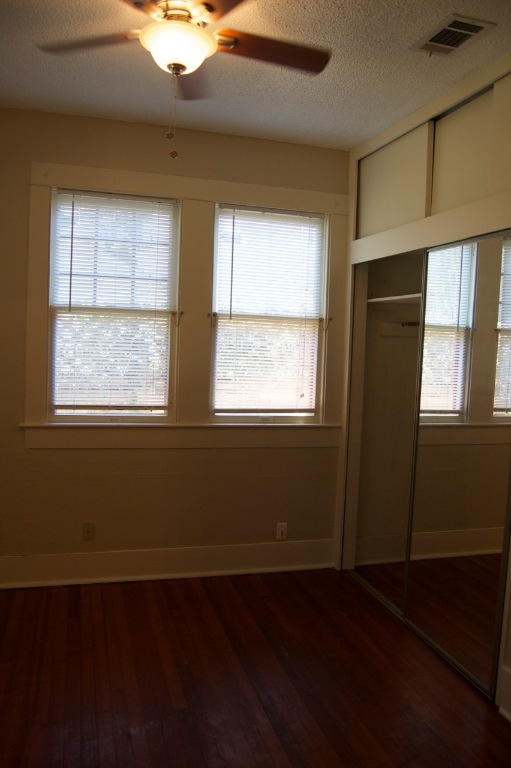 403 East 35th Street Austin, TX 78705 - Photo 13 of 14 a view of an empty room with wooden floor and a window