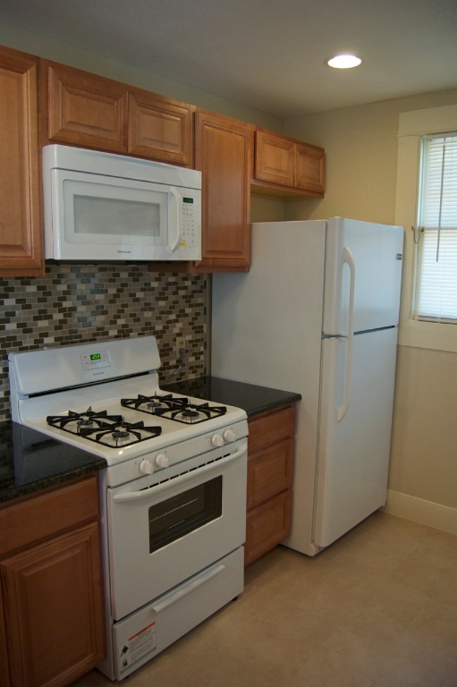 403 East 35th Street Austin, TX 78705 - Photo 7 of 14 a white stove top oven sitting inside of a kitchen