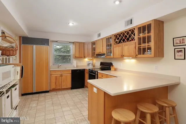 a kitchen with a sink a stove a refrigerator and cabinets