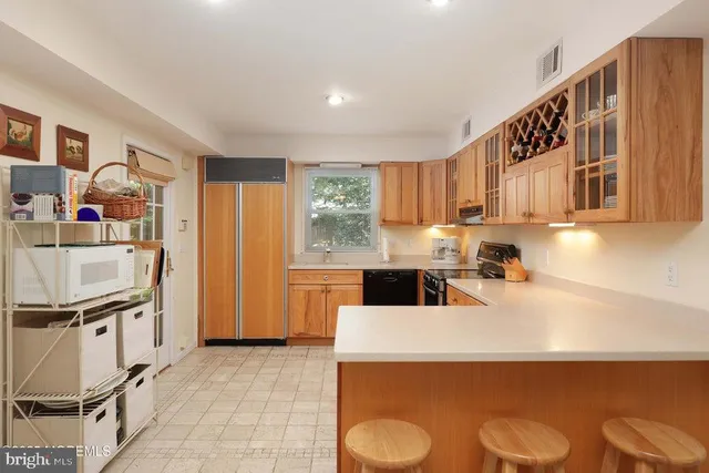 a kitchen with granite countertop a sink a stove and refrigerator