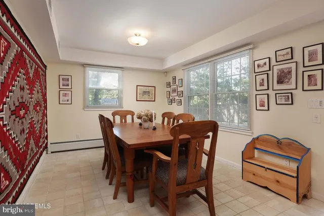 a view of a dining room with furniture a couch and wooden floor