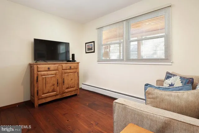 a living room with furniture and flat screen tv
