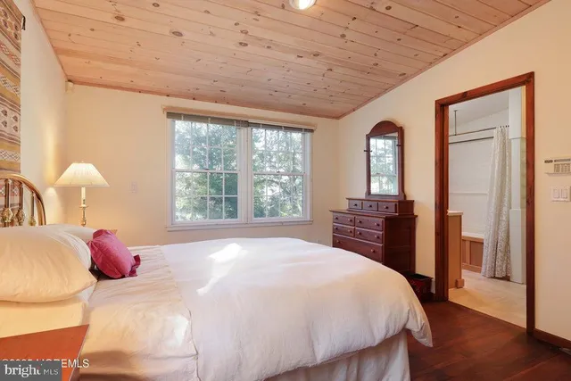 a bedroom with a large bed and a large window