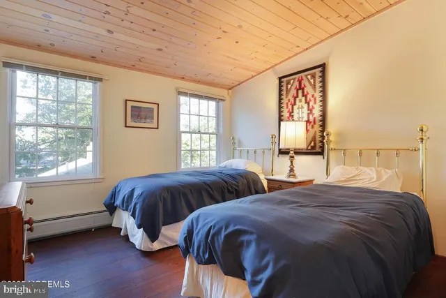 a bedroom with two beds and a window