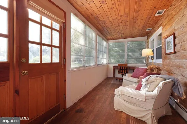 a dining room with furniture and a large window