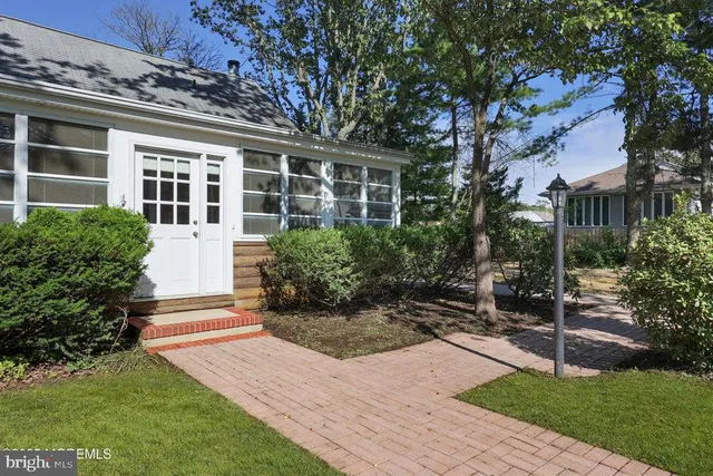 a view of backyard of house with green space
