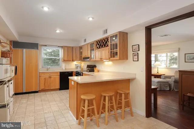 a kitchen with stainless steel appliances kitchen island granite countertop a stove and a refrigerator