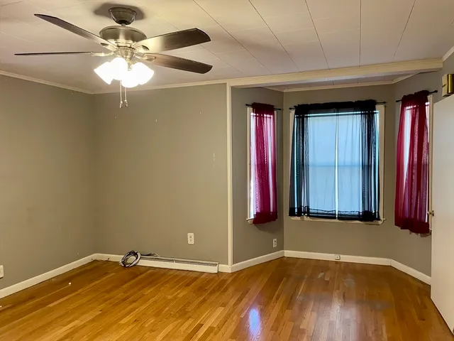 a view of a room with a chandelier and a ceiling fan