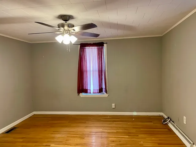 a view of a room with window and wooden floor
