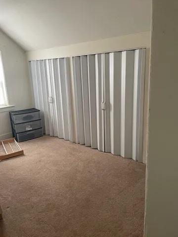 a room with a large window and furniture