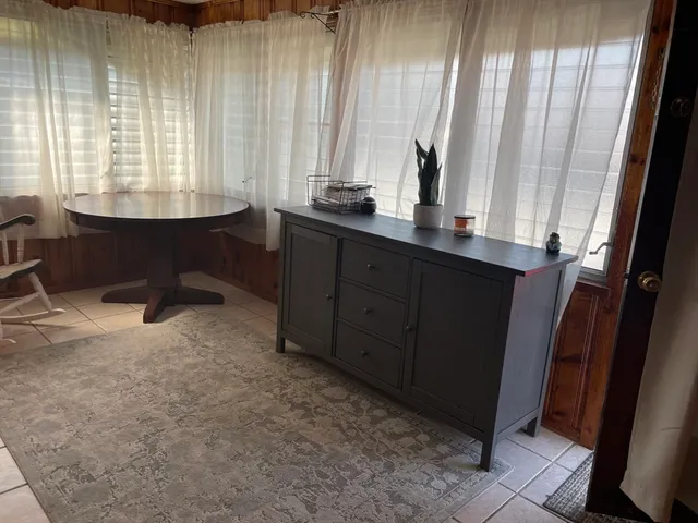 a view of a patio with table and chairs with wooden floor and fence