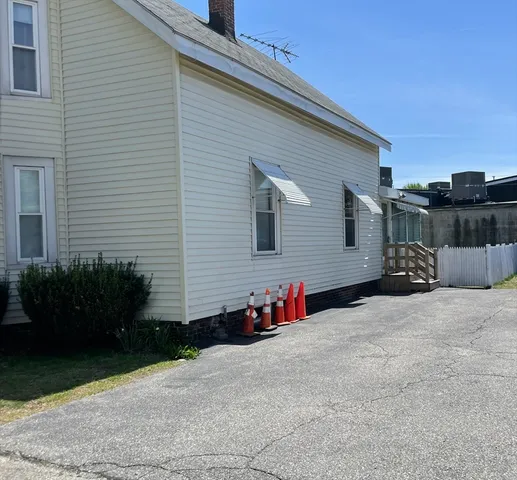a backyard of a house with potted plants