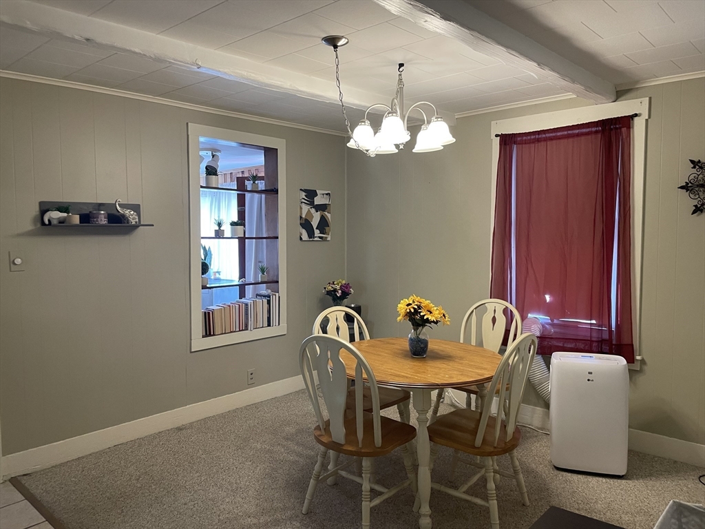 15 Green Street Reading, MA 01867 - Photo 10 of 34 a view of a dining room with furniture chandelier and a window