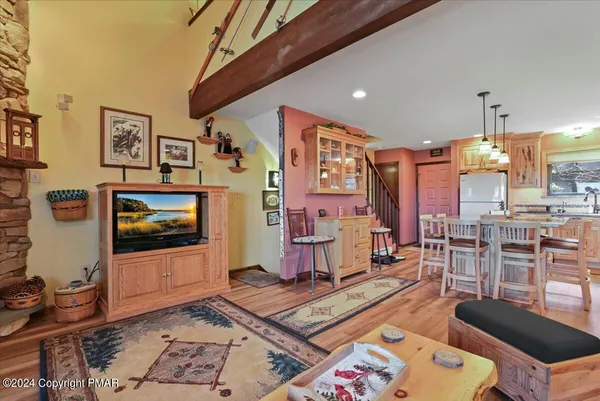 a living room with furniture a rug and a fireplace