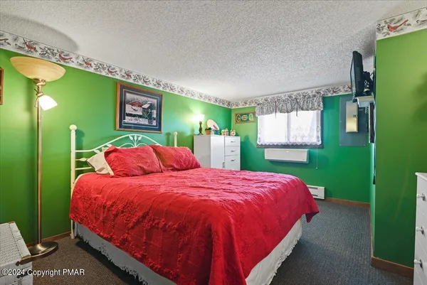 a bed sitting in a bedroom next to a window