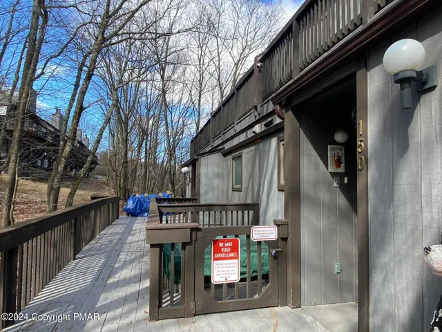 a bathroom with a tub sink and wooden floor