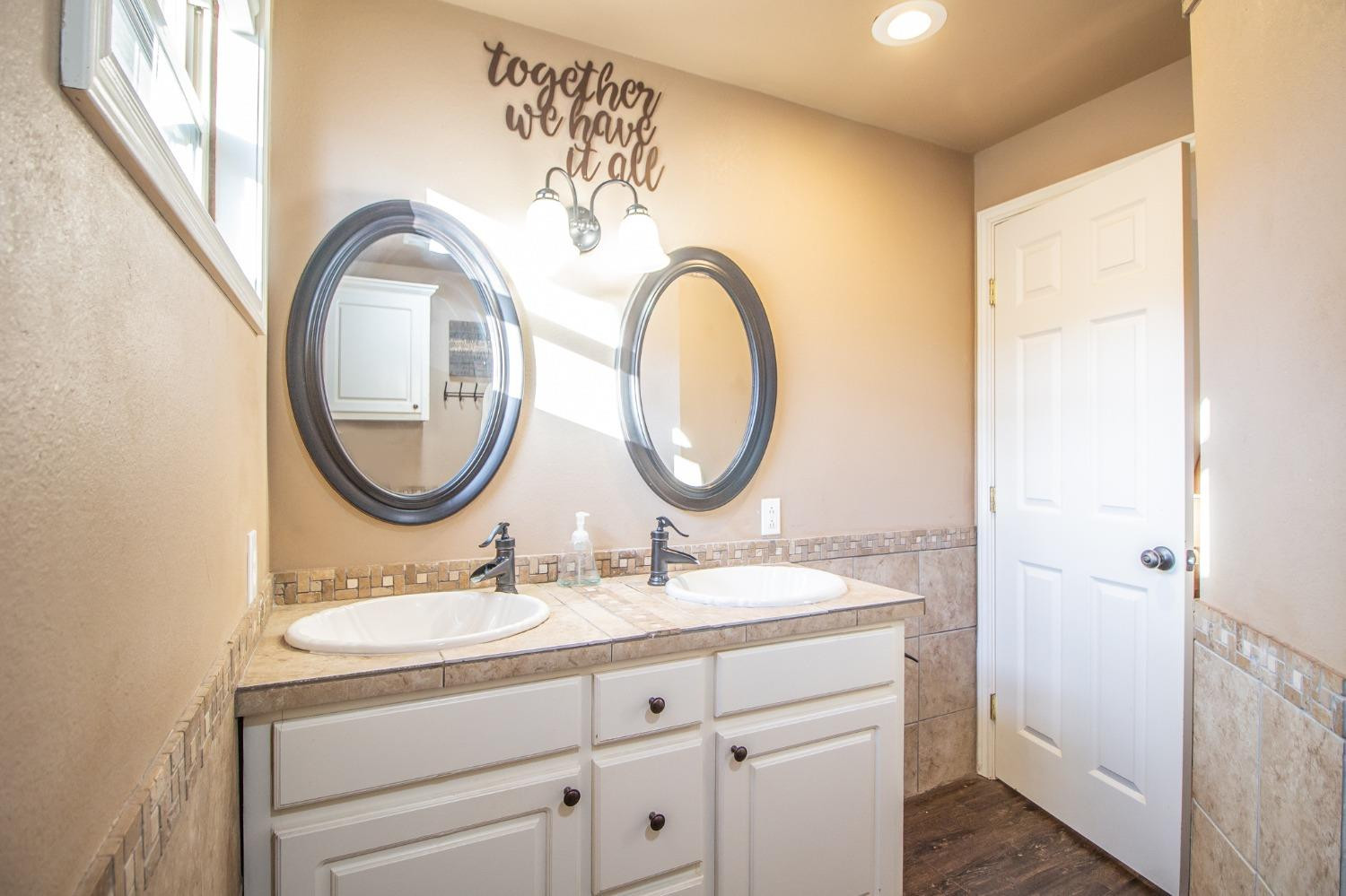 148 Pony Express Trail Lubbock, TX 79404 - Photo 16 of 29 a bathroom with a sink and a mirror