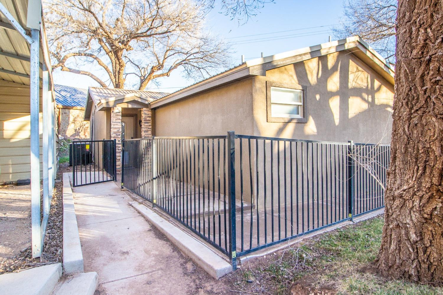 148 Pony Express Trail Lubbock, TX 79404 - Photo 23 of 29 a view of a yard with wooden fence and floor