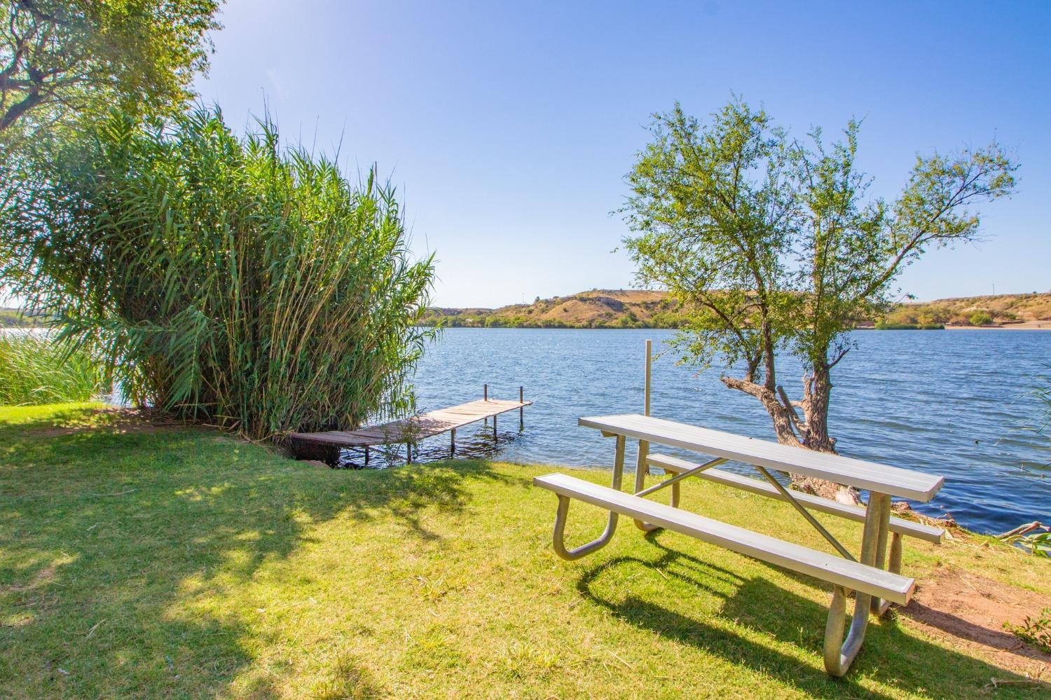 148 Pony Express Trail Lubbock, TX 79404 - Photo 28 of 29 a view of a swimming pool with a bench and trees around