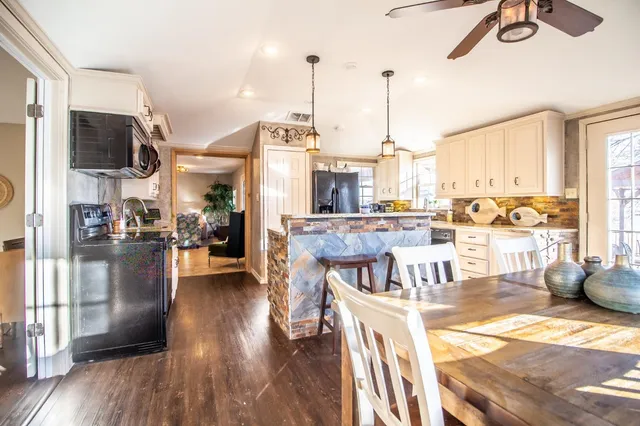 a kitchen with stainless steel appliances granite countertop a refrigerator and a stove
