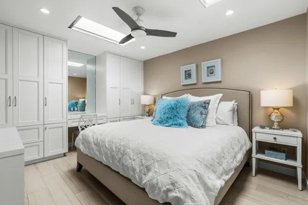 a bedroom with a bed and a chandelier
