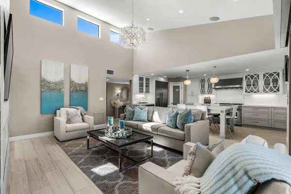 a living room with furniture and a chandelier