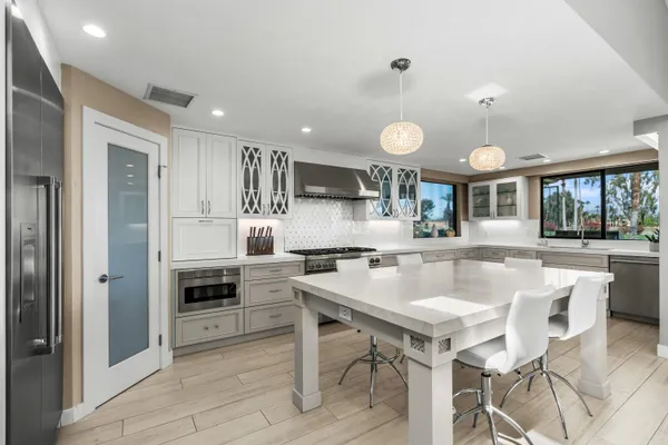 a kitchen with kitchen island cabinets and refrigerator