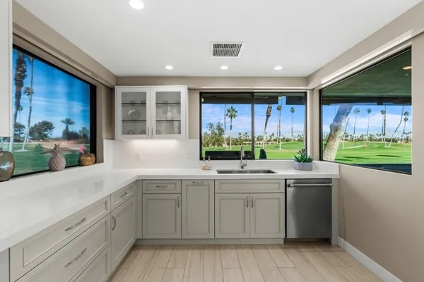 a kitchen with a sink stove and cabinets