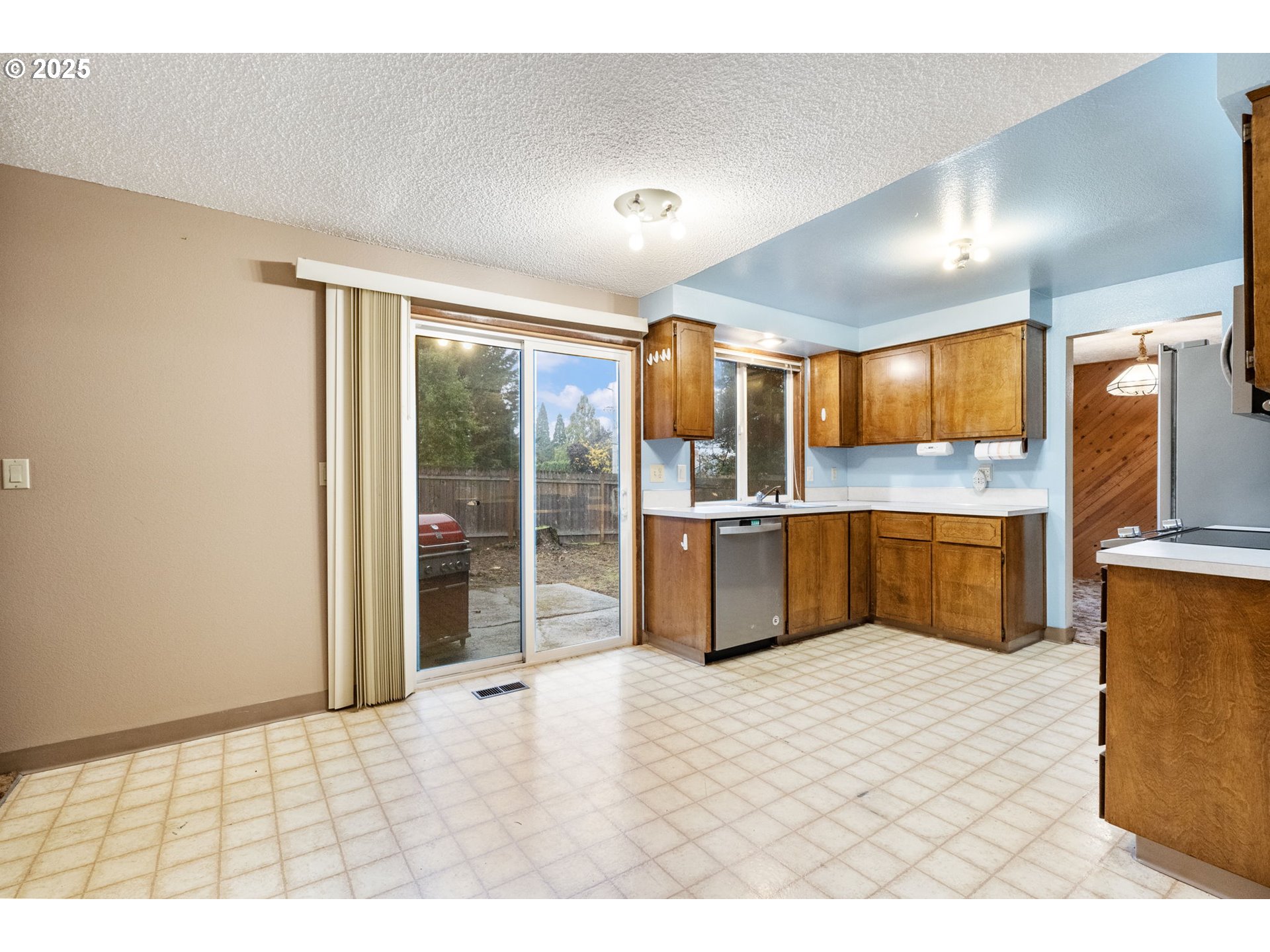 470 Southwest 194th Court Beaverton, OR 97006 - Photo 13 of 31 a kitchen with granite countertop a sink cabinets and stainless steel appliances