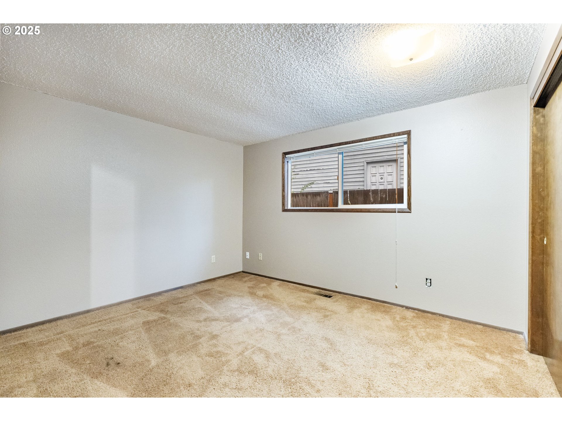 470 Southwest 194th Court Beaverton, OR 97006 - Photo 23 of 31 a view of an empty room with a window