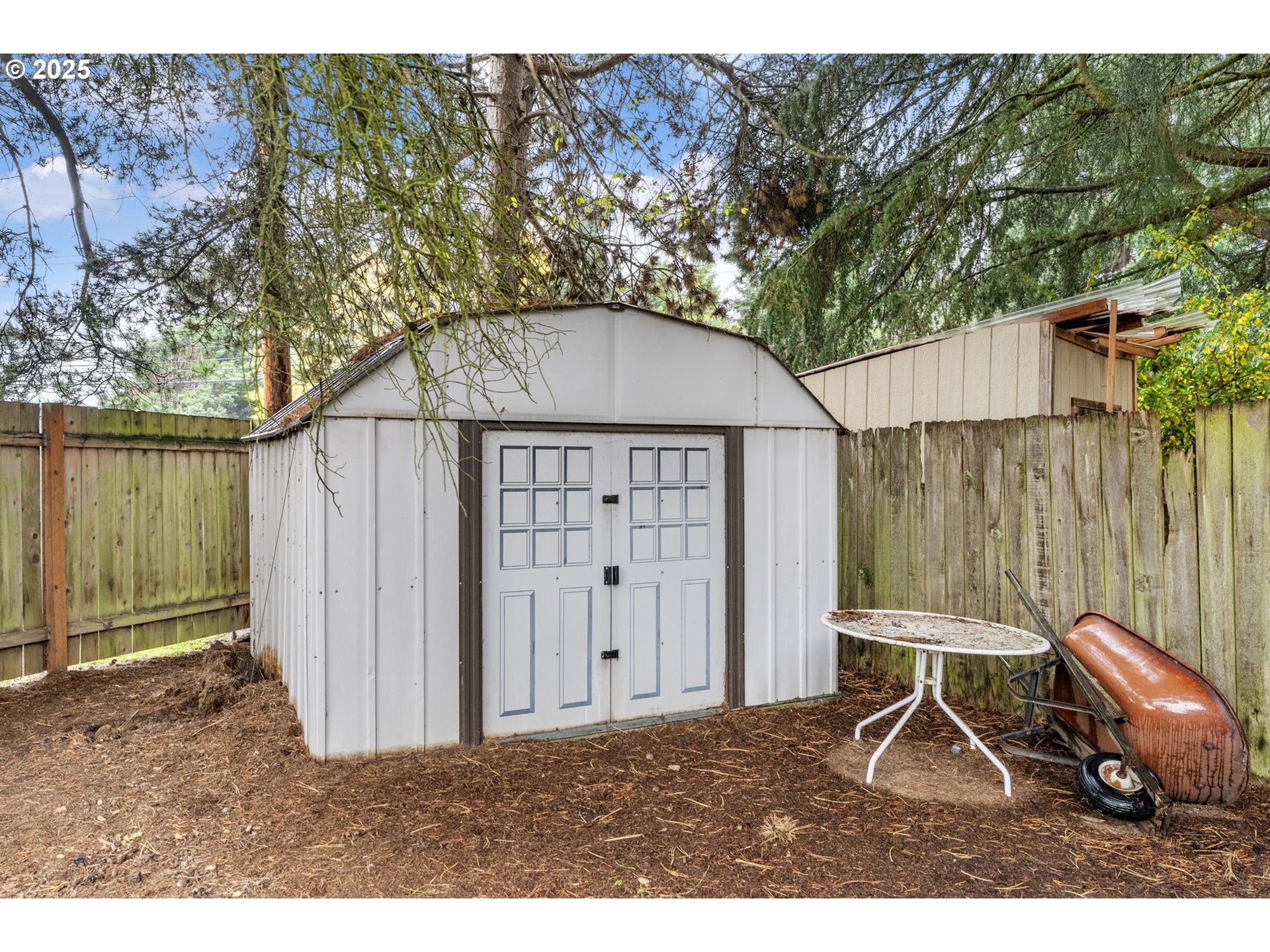 470 Southwest 194th Court Beaverton, OR 97006 - Photo 31 of 31 a backyard of a house with lawn chairs and wooden fence