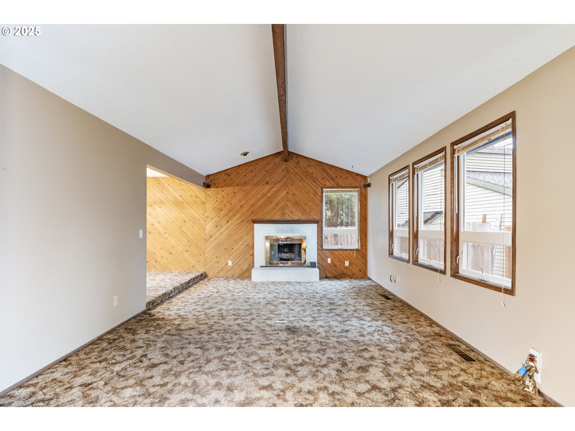 470 Southwest 194th Court Beaverton, OR 97006 - Photo 6 of 31 a view of an empty room with a fireplace and a window