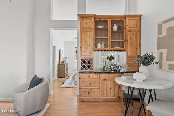 a living room with furniture a flat screen tv and a floor to ceiling window