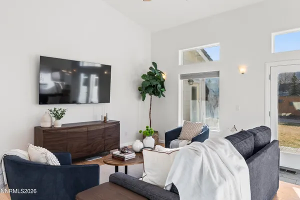 a living room with furniture and a chandelier
