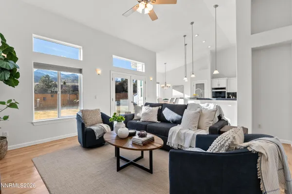 a living room with furniture a flat screen tv and kitchen view
