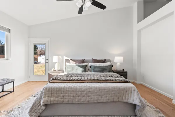 a bedroom with a large bed and a chandelier