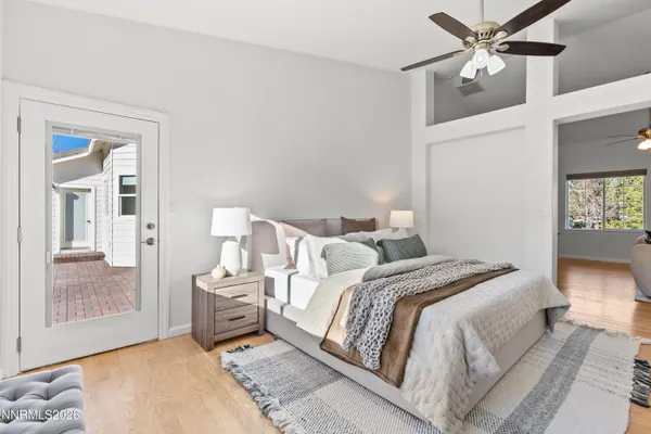 a bedroom with a bed and ceiling fan