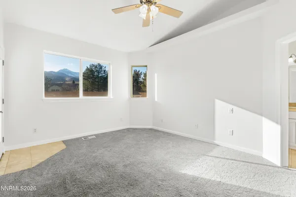 an empty room with a ceiling fan