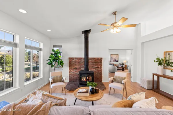 a living room with furniture potted plant and a large window