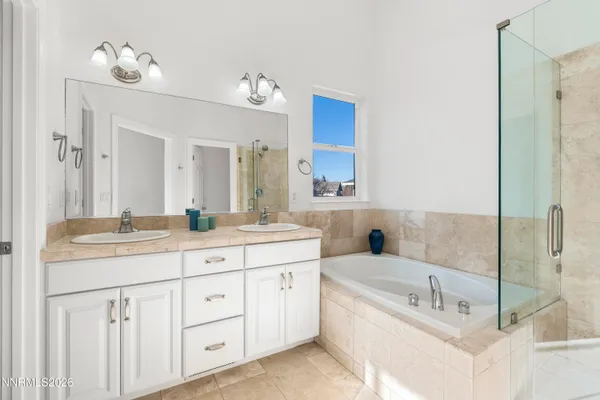 a bathroom with a tub sink toilet and shower