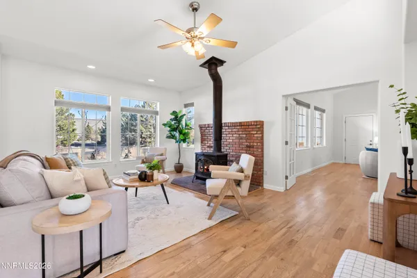 a living room with furniture a fireplace and a chandelier