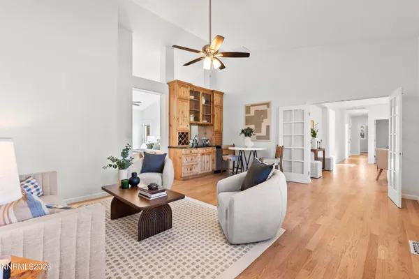 a living room with furniture and a chandelier