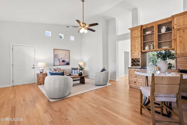 a living room with furniture and a chandelier