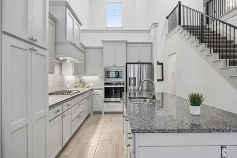 a kitchen with counter top space cabinets and stainless steel appliances