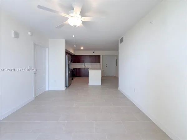 a view of a kitchen with a sink and a refrigerator