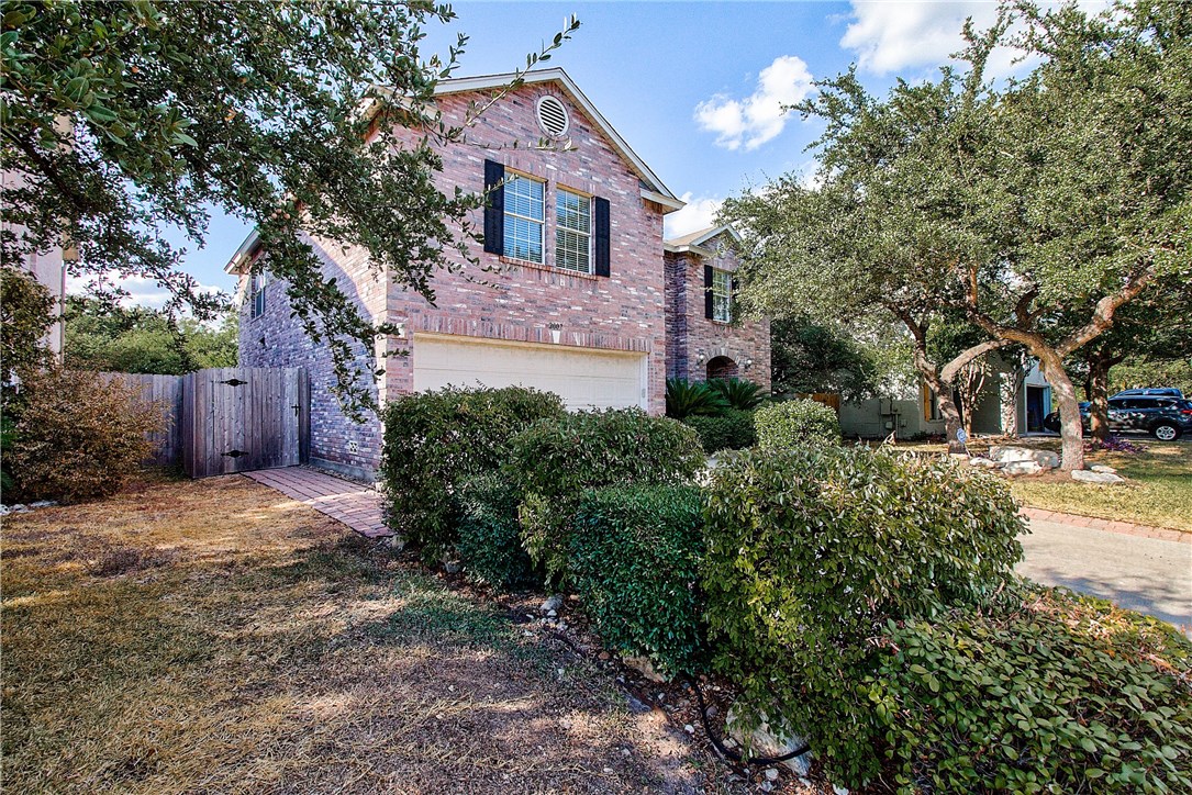 2007 Rachel Ridge Cedar Park, TX 78613 - Photo 1 of 1 a backyard of a house with plants and tree
