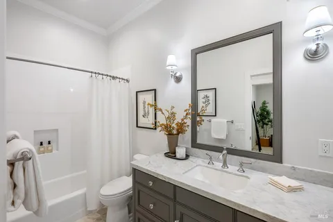 a bathroom with a granite countertop sink toilet and shower
