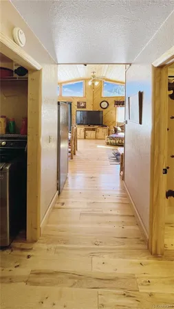 a view of kitchen with furniture and refrigerator
