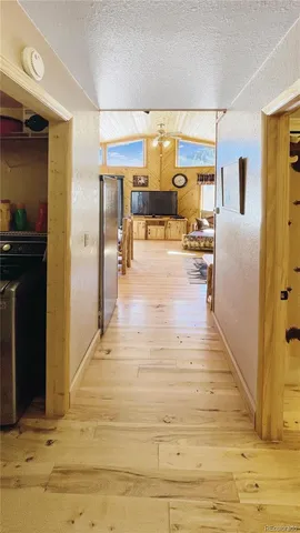 a view of kitchen with furniture and refrigerator