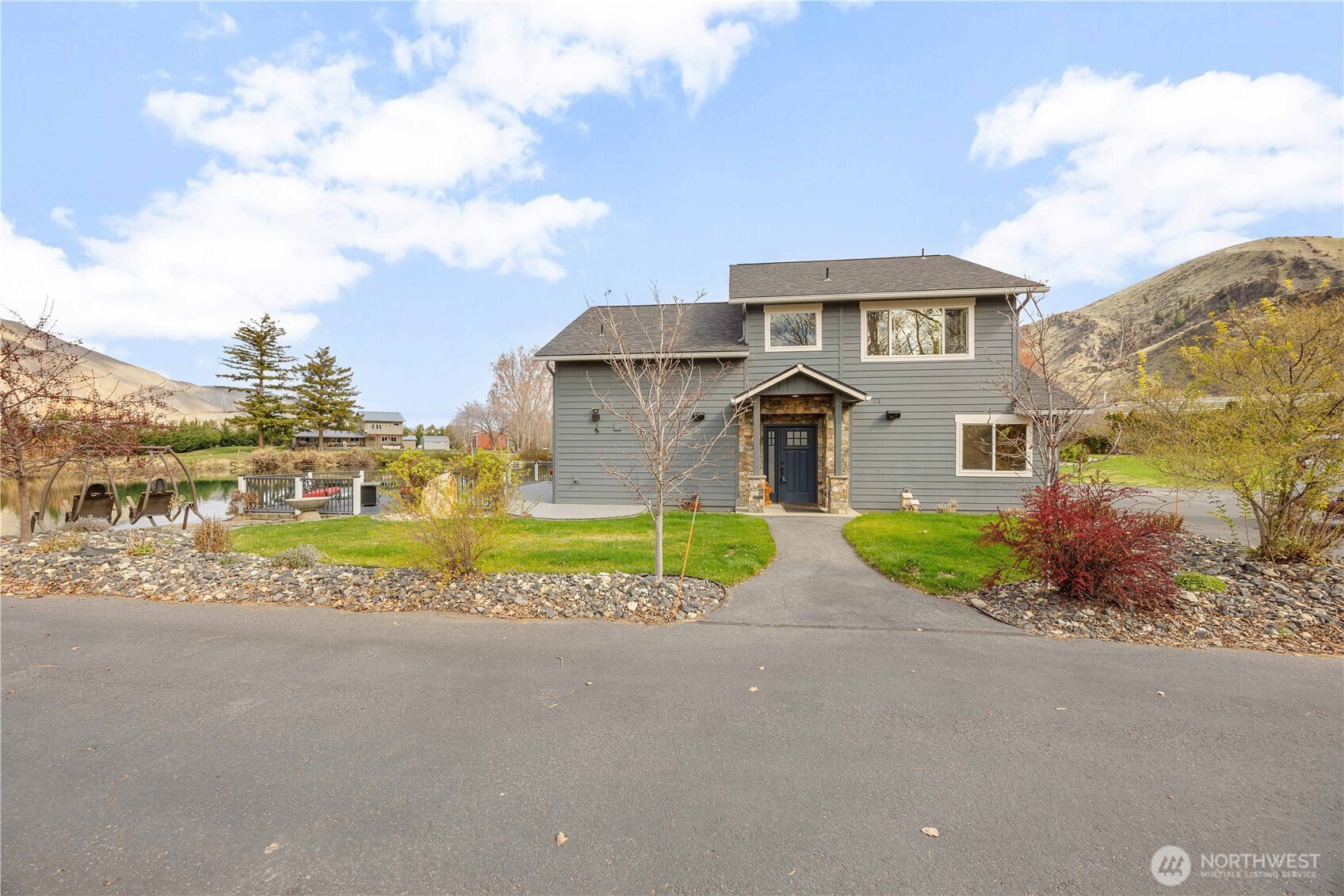 2 Playland Court Orondo, WA 98843 - Photo 27 of 40 a front view of a house with a garden and pathway